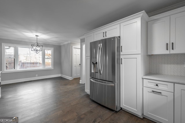 kitchen with white cabinets, stainless steel refrigerator with ice dispenser, decorative light fixtures, and tasteful backsplash