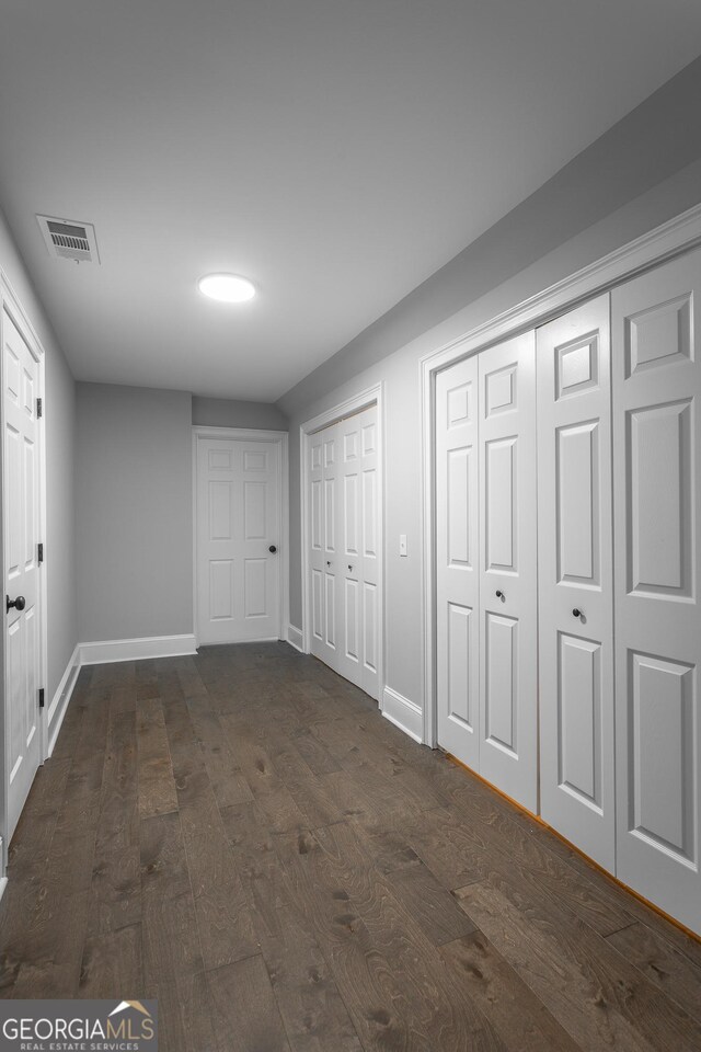 unfurnished dining area featuring ceiling fan with notable chandelier, dark hardwood / wood-style flooring, and ornamental molding