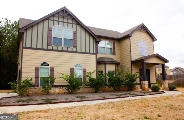 view of front of property featuring fence and board and batten siding