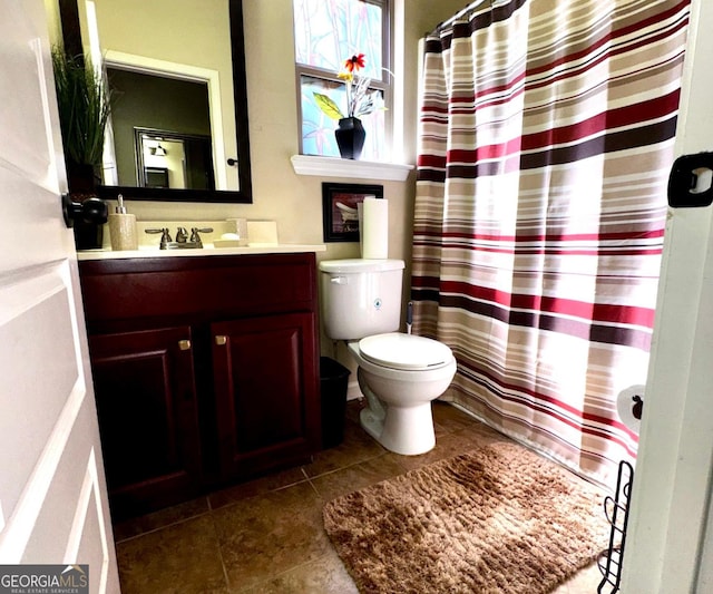 bathroom featuring vanity, tile patterned floors, curtained shower, and toilet