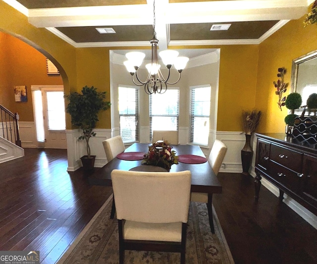 dining room featuring a chandelier, a wainscoted wall, and a healthy amount of sunlight