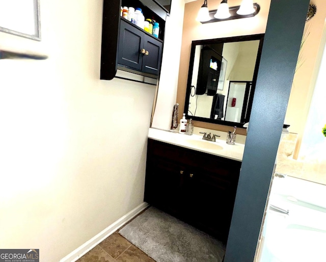 bathroom with vanity and baseboards