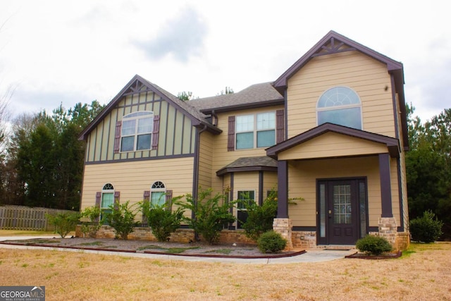 view of front of home with a front yard and roof with shingles