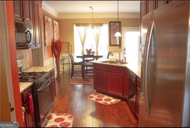 kitchen with dark wood-type flooring, black appliances, a sink, reddish brown cabinets, and crown molding