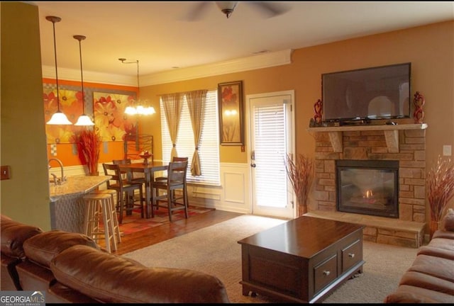 living area featuring a decorative wall, wainscoting, and a fireplace