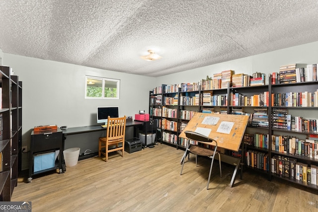 office space featuring wood-type flooring and a textured ceiling