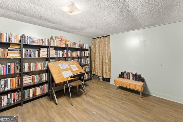 sitting room featuring a textured ceiling and hardwood / wood-style flooring