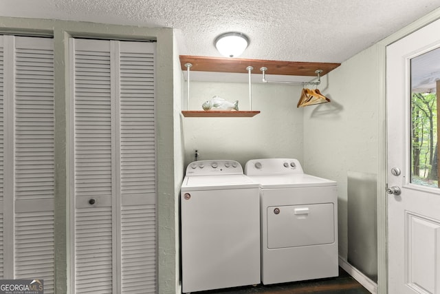 laundry area featuring independent washer and dryer and a textured ceiling