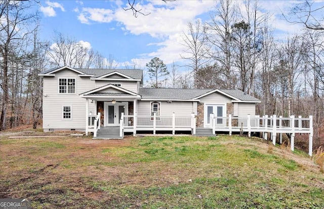 view of front of home featuring french doors, a deck, a front lawn, and ceiling fan