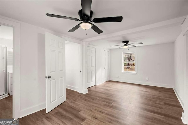 unfurnished bedroom with dark hardwood / wood-style flooring and ceiling fan