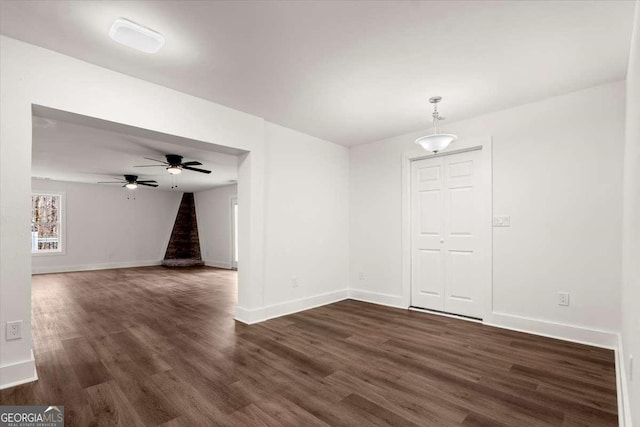 spare room with dark hardwood / wood-style floors and ceiling fan