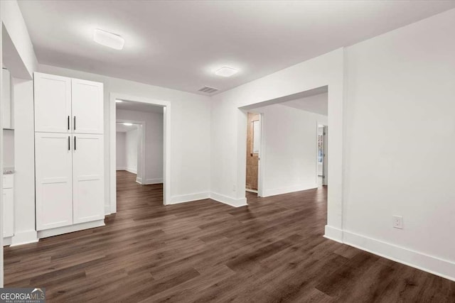 spare room with dark hardwood / wood-style flooring