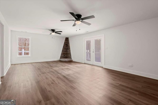 unfurnished living room featuring ceiling fan, french doors, and hardwood / wood-style flooring