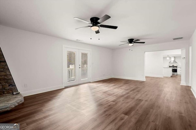 unfurnished living room featuring ceiling fan and dark wood-type flooring