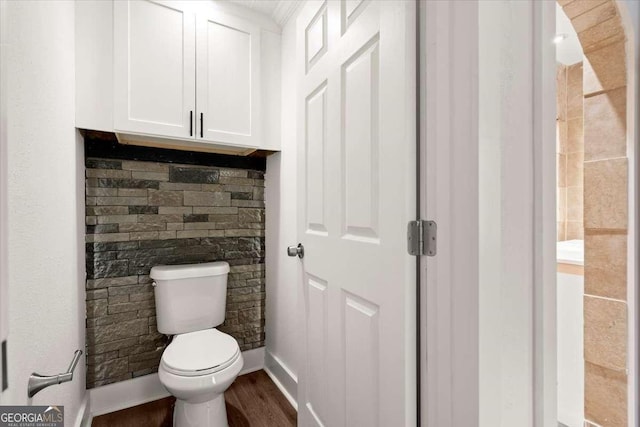 bathroom with hardwood / wood-style flooring and toilet