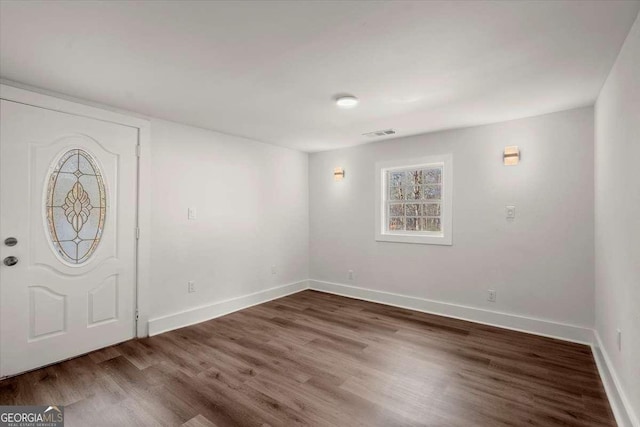 foyer entrance featuring dark wood-type flooring