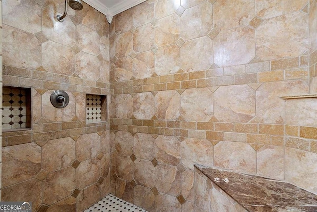 interior details with a tile shower and ornamental molding