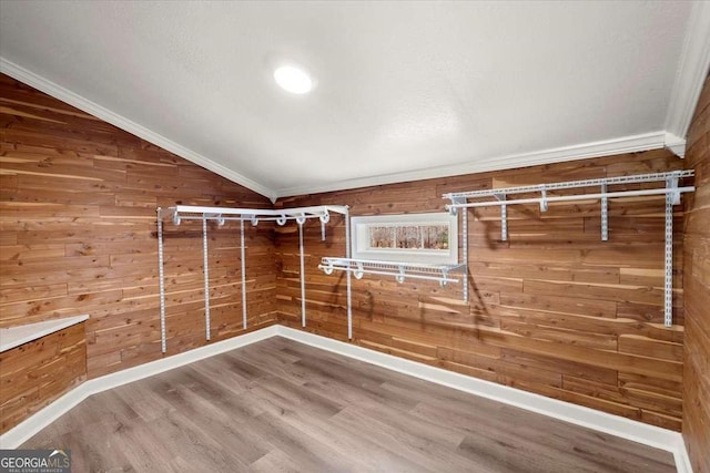 spacious closet with hardwood / wood-style floors and vaulted ceiling