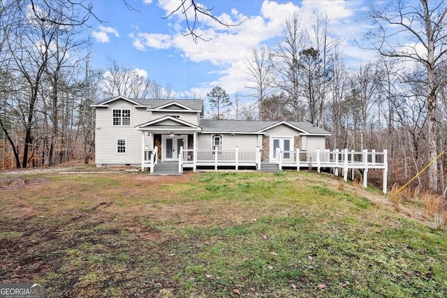 view of front facade featuring a front lawn and a wooden deck