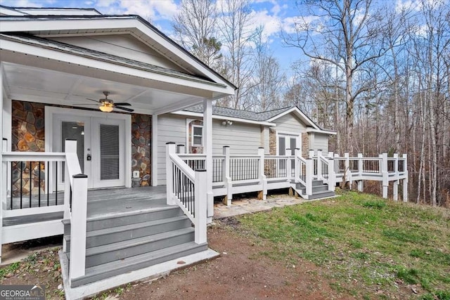 exterior space with ceiling fan and a lawn