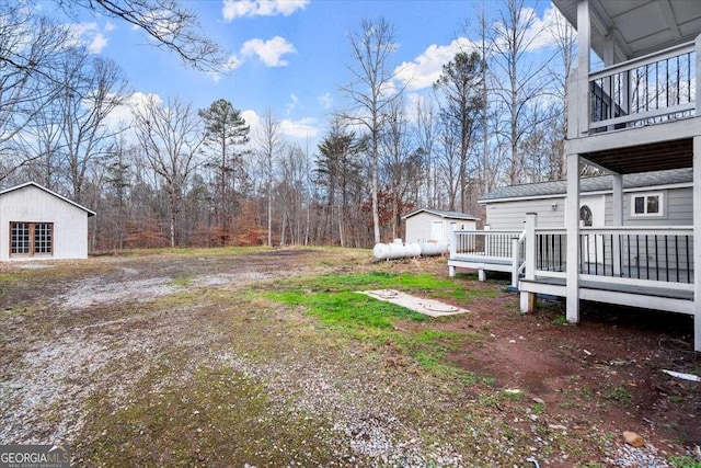 view of yard with a wooden deck