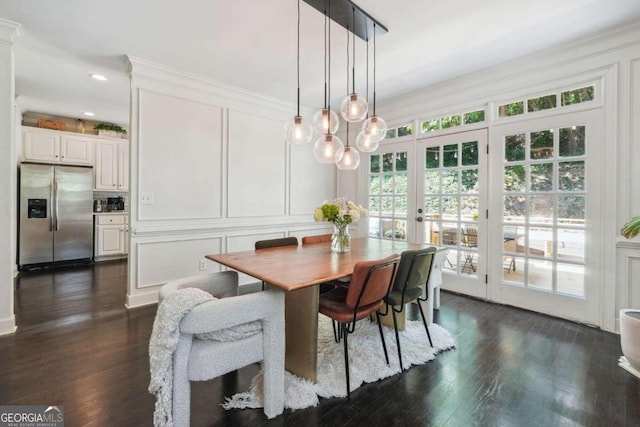 dining area featuring dark hardwood / wood-style flooring and ornamental molding