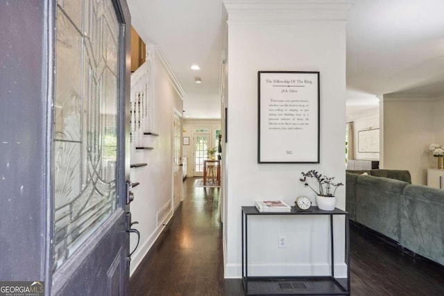 hall with dark hardwood / wood-style flooring and ornamental molding