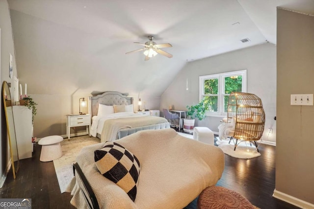 bedroom with ceiling fan, dark wood-type flooring, and lofted ceiling