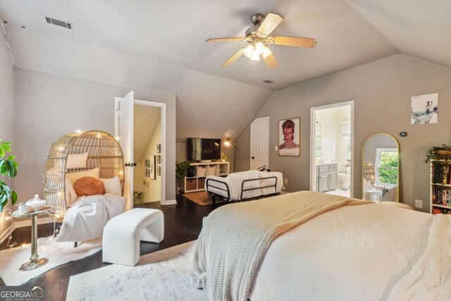 bedroom with wood-type flooring, connected bathroom, vaulted ceiling, and ceiling fan