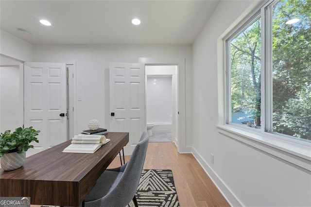 home office featuring light wood-type flooring, baseboards, and recessed lighting