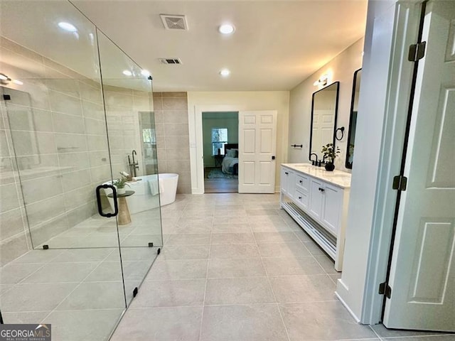 full bath featuring double vanity, a soaking tub, tile patterned flooring, and visible vents