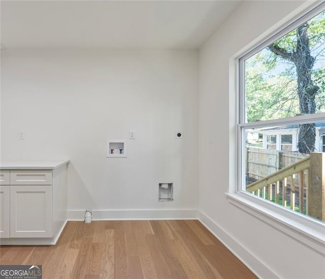 laundry area with laundry area, washer hookup, light wood-style floors, baseboards, and electric dryer hookup