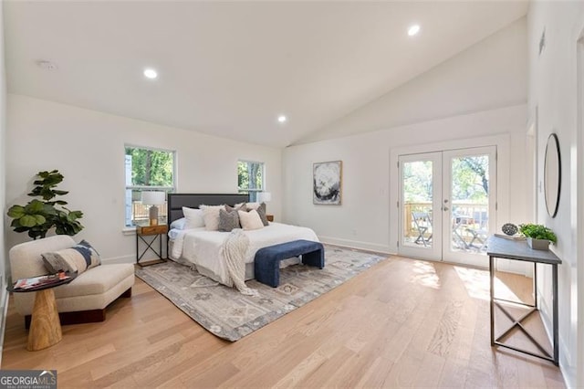 bedroom featuring lofted ceiling, access to outside, light hardwood / wood-style floors, and french doors