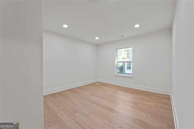 sitting room with lofted ceiling, a fireplace, and light hardwood / wood-style flooring