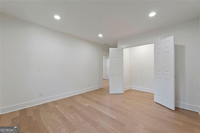 unfurnished bedroom featuring light wood-type flooring, baseboards, and recessed lighting