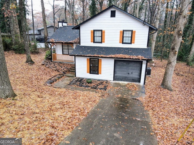 view of front of property with cooling unit and a garage