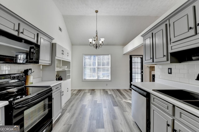 kitchen with decorative backsplash, gray cabinetry, vaulted ceiling, black appliances, and light hardwood / wood-style flooring