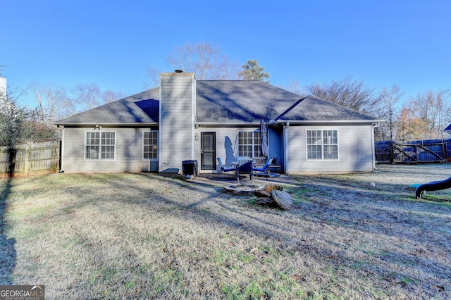 back of house with a yard