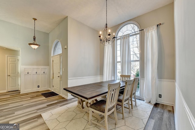 dining space with light wood-type flooring and a chandelier