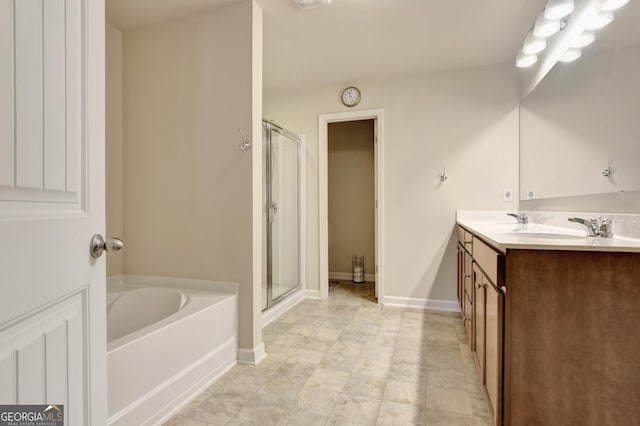 bathroom with vanity and shower with separate bathtub