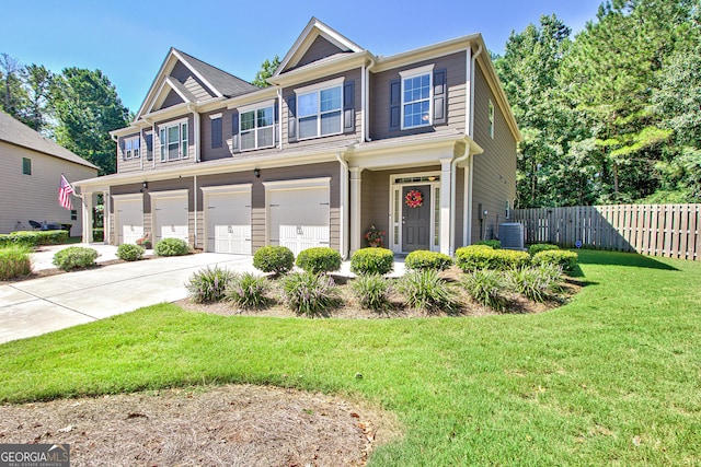 view of front of property featuring central AC, a garage, and a front lawn