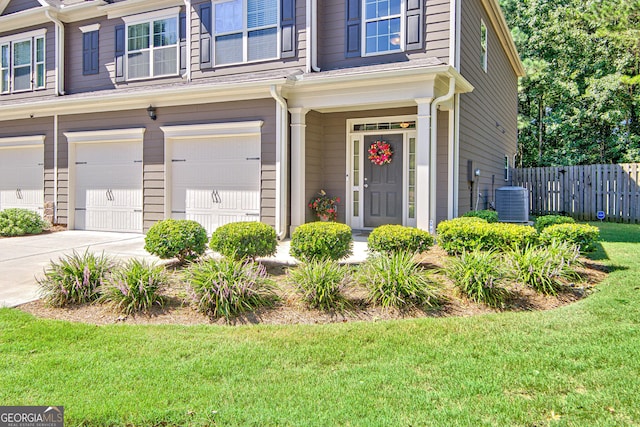 entrance to property with central AC and a garage