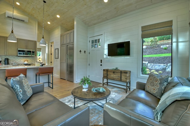 living room featuring an AC wall unit, wood walls, light hardwood / wood-style flooring, and high vaulted ceiling