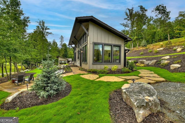 rear view of property featuring a yard