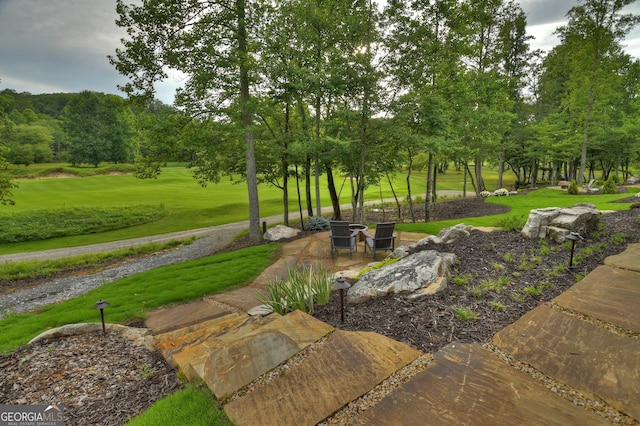 view of property's community with a lawn