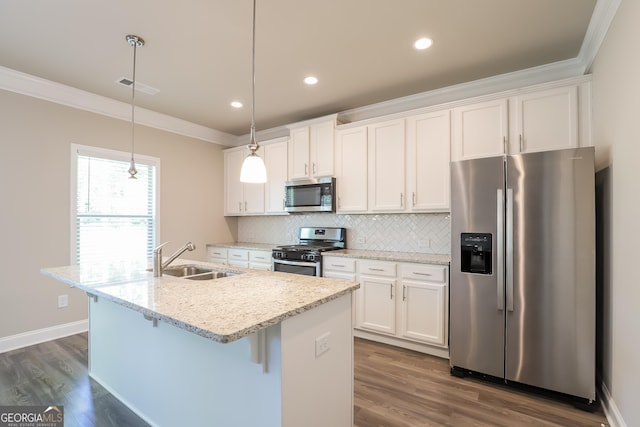 kitchen featuring stainless steel appliances, sink, pendant lighting, a center island with sink, and white cabinetry