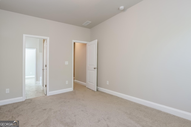 unfurnished bedroom featuring light colored carpet