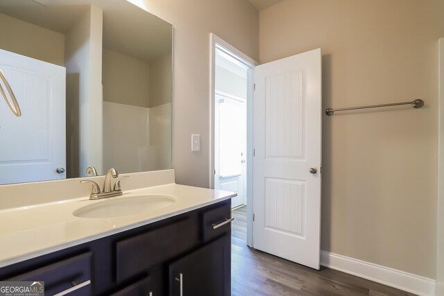 bathroom with vanity and wood-type flooring