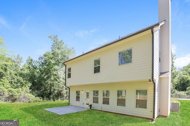 back of house with a yard and a patio area