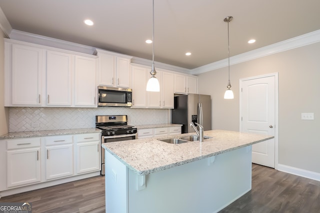 kitchen with white cabinetry, a center island with sink, decorative light fixtures, and appliances with stainless steel finishes